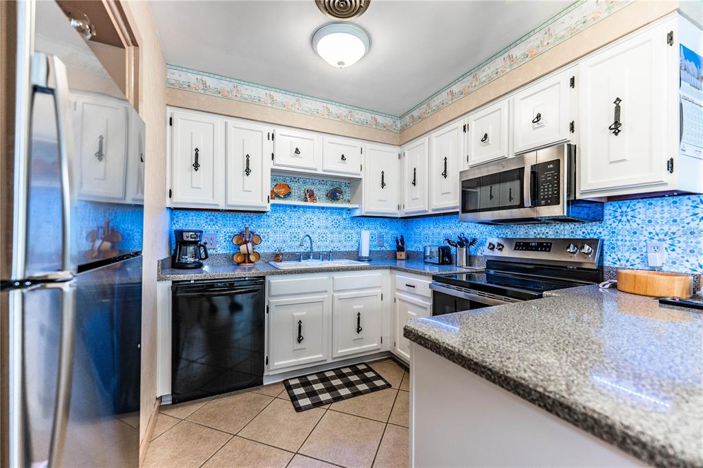 1305 Arbuckle Creek Road Sebring, FL 33870 - Photo 23 of 71 a kitchen with stainless steel appliances granite countertop a stove sink and cabinets