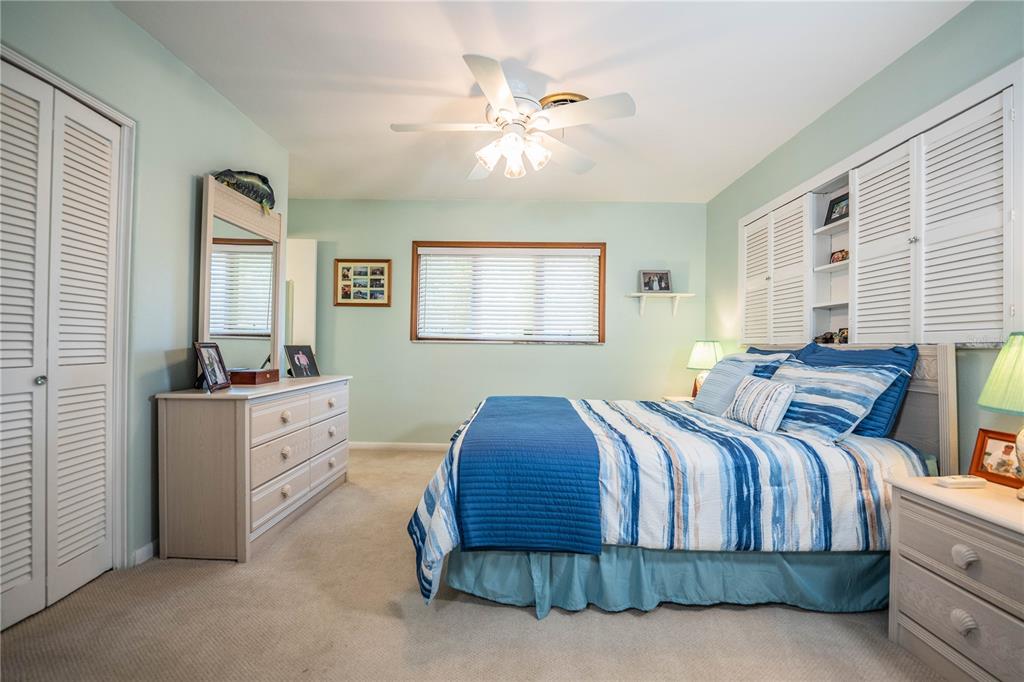 1305 Arbuckle Creek Road Sebring, FL 33870 - Photo 27 of 71 a bedroom with a large bed and a chandelier