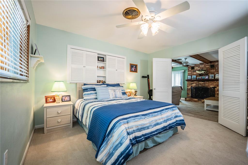 1305 Arbuckle Creek Road Sebring, FL 33870 - Photo 29 of 71 a spacious bedroom with a bed and a chandelier