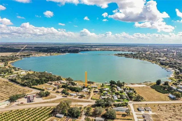 a view of a house with a yard patio and fire pit