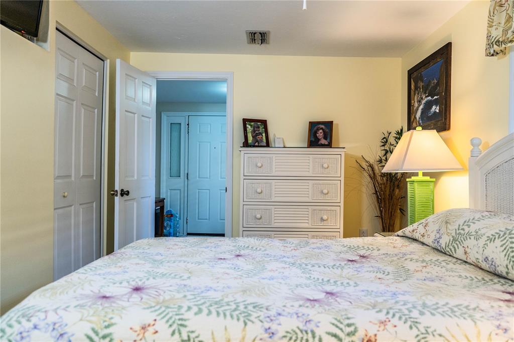 1305 Arbuckle Creek Road Sebring, FL 33870 - Photo 42 of 71 a bedroom with a bed and a mirror