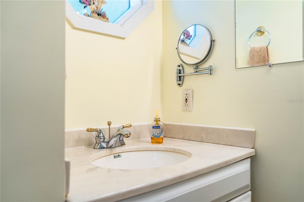 1305 Arbuckle Creek Road Sebring, FL 33870 - Photo 46 of 71 a bathroom with a sink and a mirror