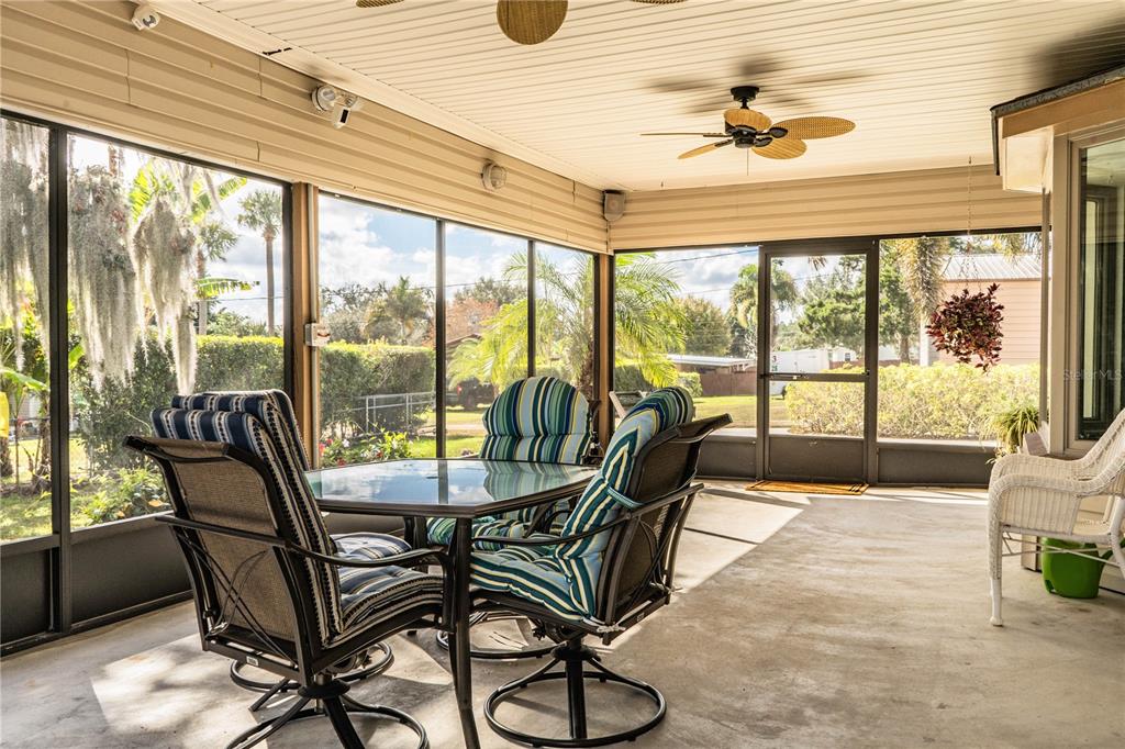 1305 Arbuckle Creek Road Sebring, FL 33870 - Photo 50 of 71 a dining room with furniture water view and a floor to ceiling window