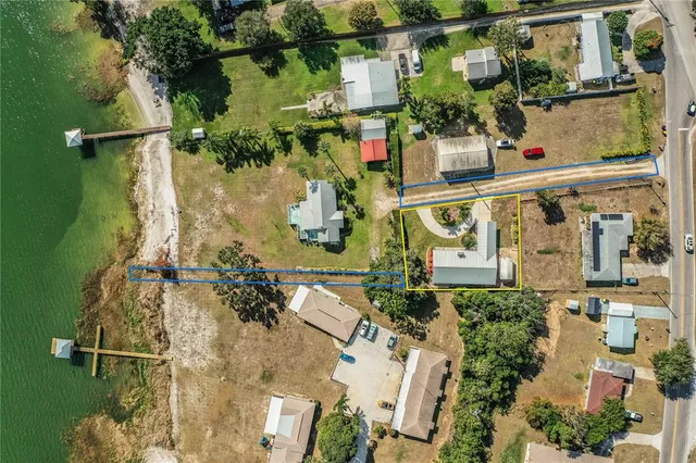 a view of a patio with table and chairs and floor to ceiling window with wooden floor