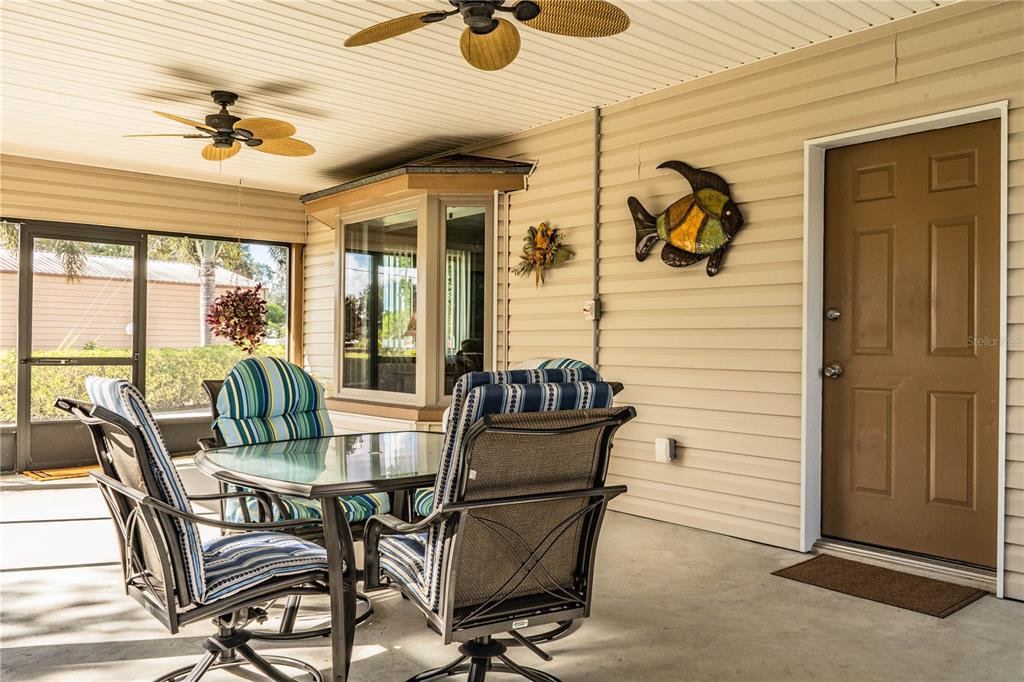 1305 Arbuckle Creek Road Sebring, FL 33870 - Photo 55 of 71 a dining room with furniture and floor to ceiling window
