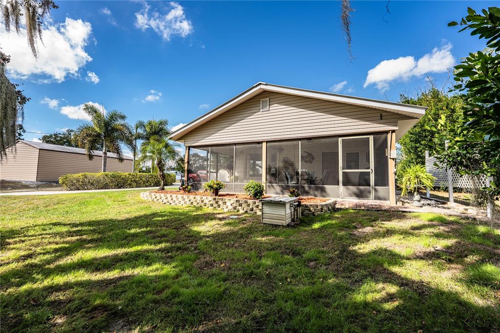 1305 Arbuckle Creek Road Sebring, FL 33870 - Photo 8 of 71 a view of a house with a yard patio and fire pit