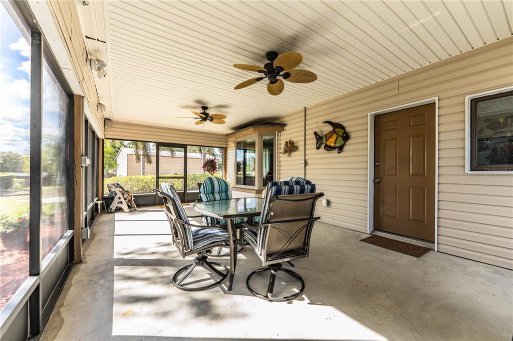 1305 Arbuckle Creek Road Sebring, FL 33870 - Photo 9 of 71 a view of a patio with table and chairs and floor to ceiling window with wooden floor