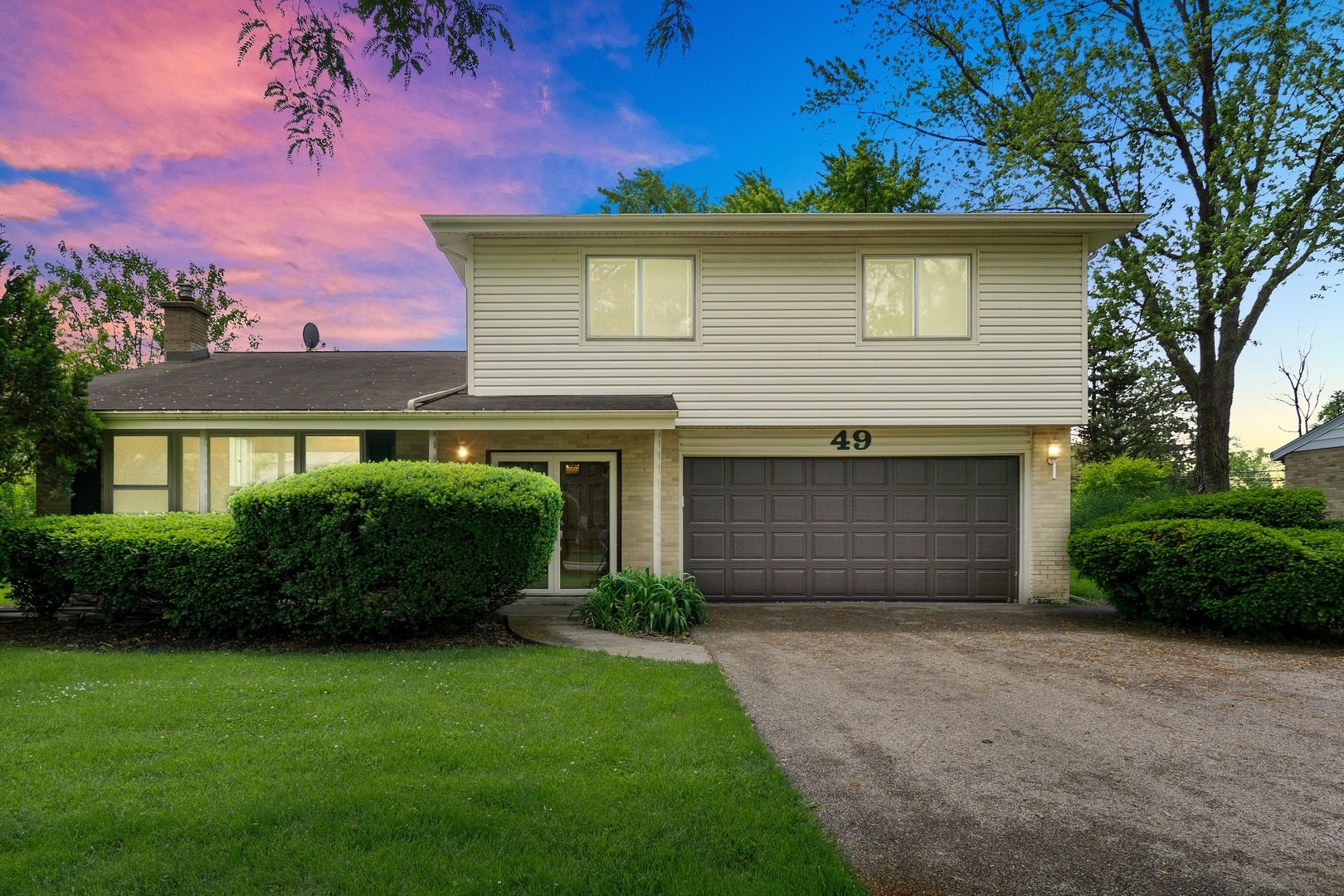 49 Mulberry Road Deerfield, IL 60015 - Photo 2 of 17 a front view of a house with a garden