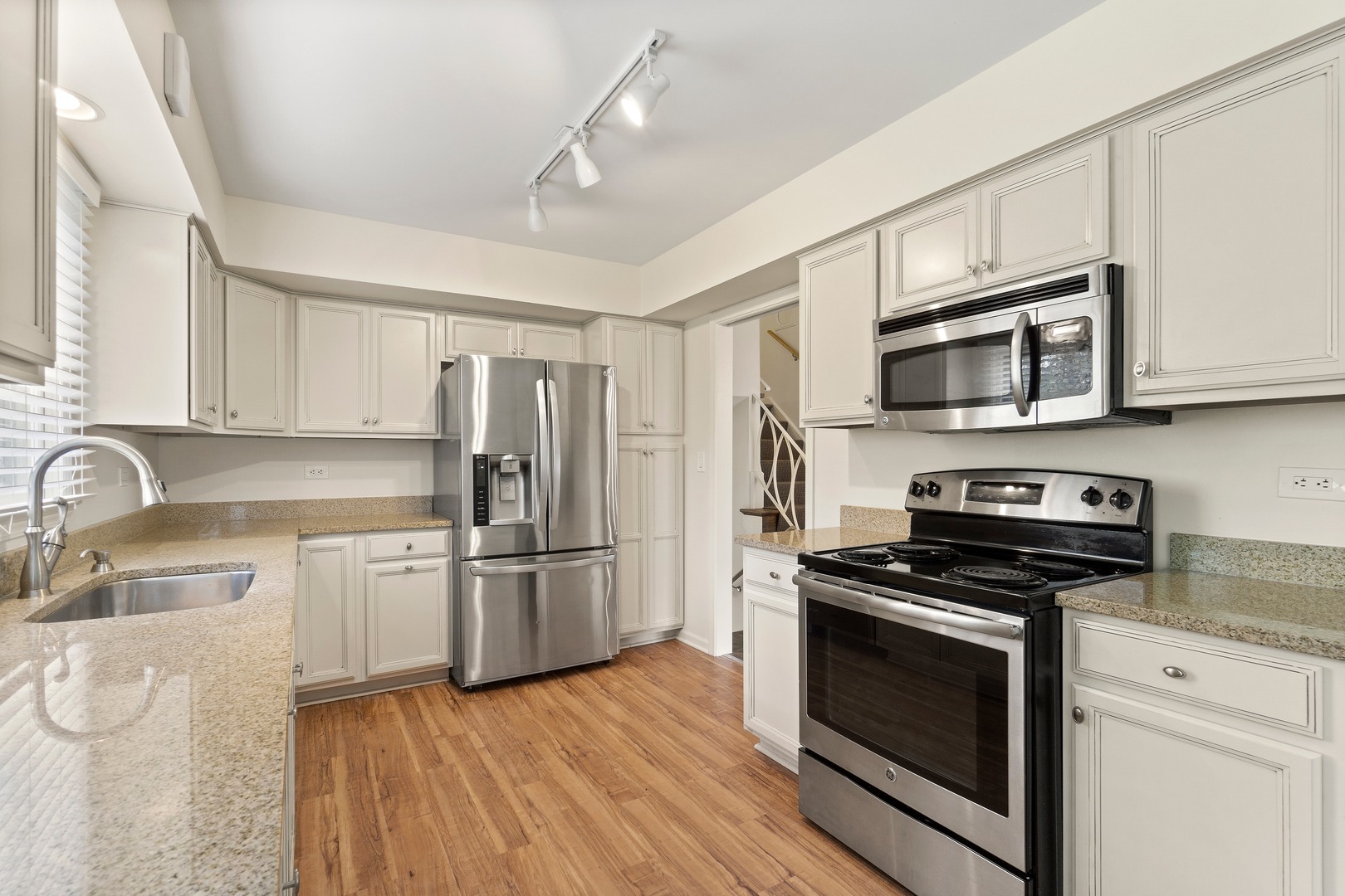 49 Mulberry Road Deerfield, IL 60015 - Photo 7 of 17 a kitchen with stainless steel appliances a stove microwave and a refrigerator