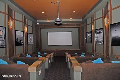 a projector room with stainless steel appliances kitchen island granite countertop a rug a stove and a refrigerator