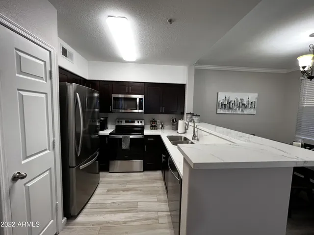 a kitchen with a refrigerator and a sink