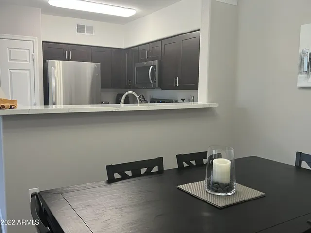 a kitchen with a sink a counter space and cabinets