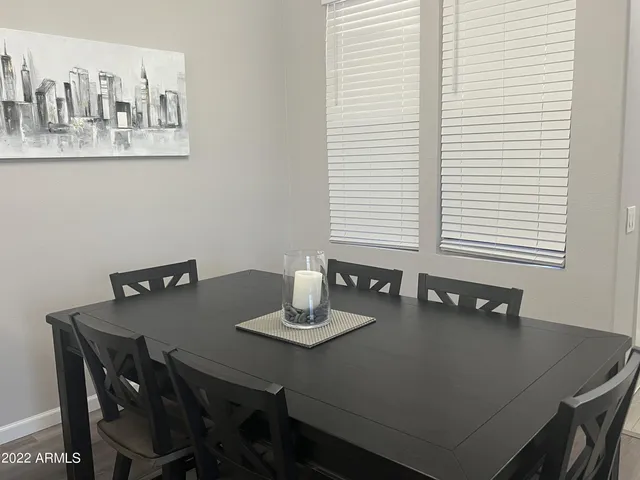 a dining room with furniture and window