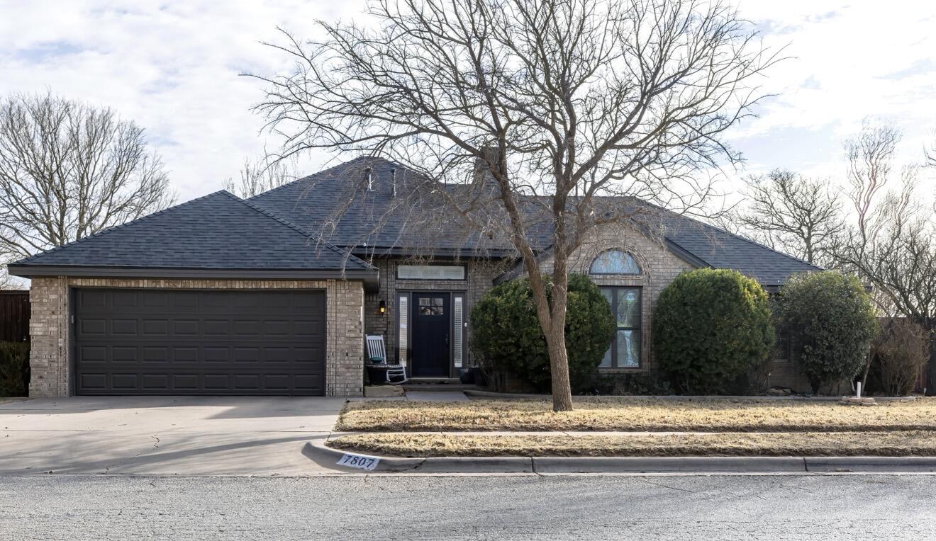 7807 Homestead Avenue Lubbock, TX 79424 - Photo 1 of 31 a front view of a house with a yard and garage