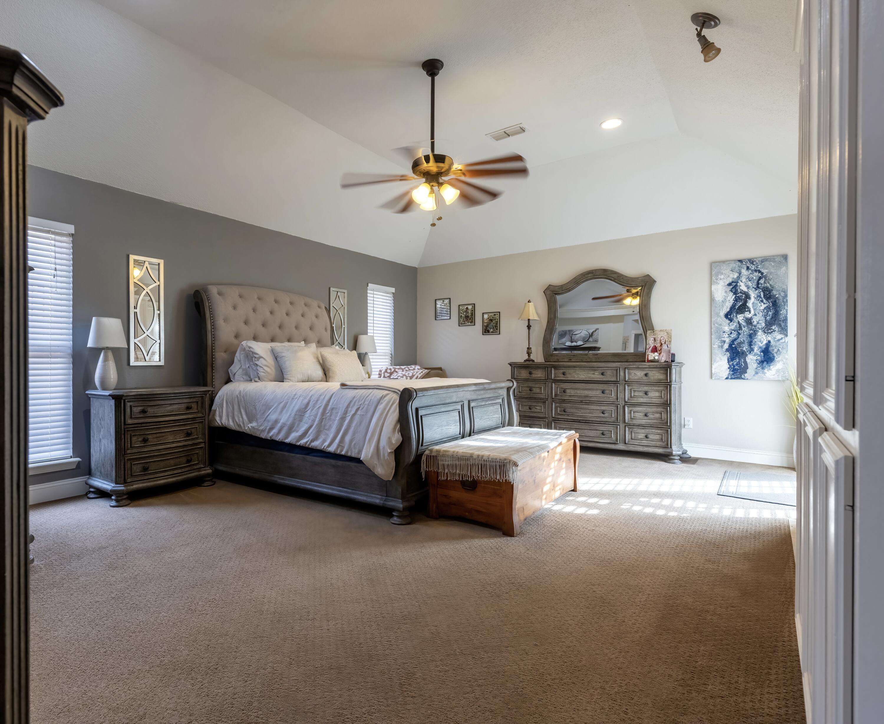 7807 Homestead Avenue Lubbock, TX 79424 - Photo 16 of 31 a bedroom with furniture and a chandelier