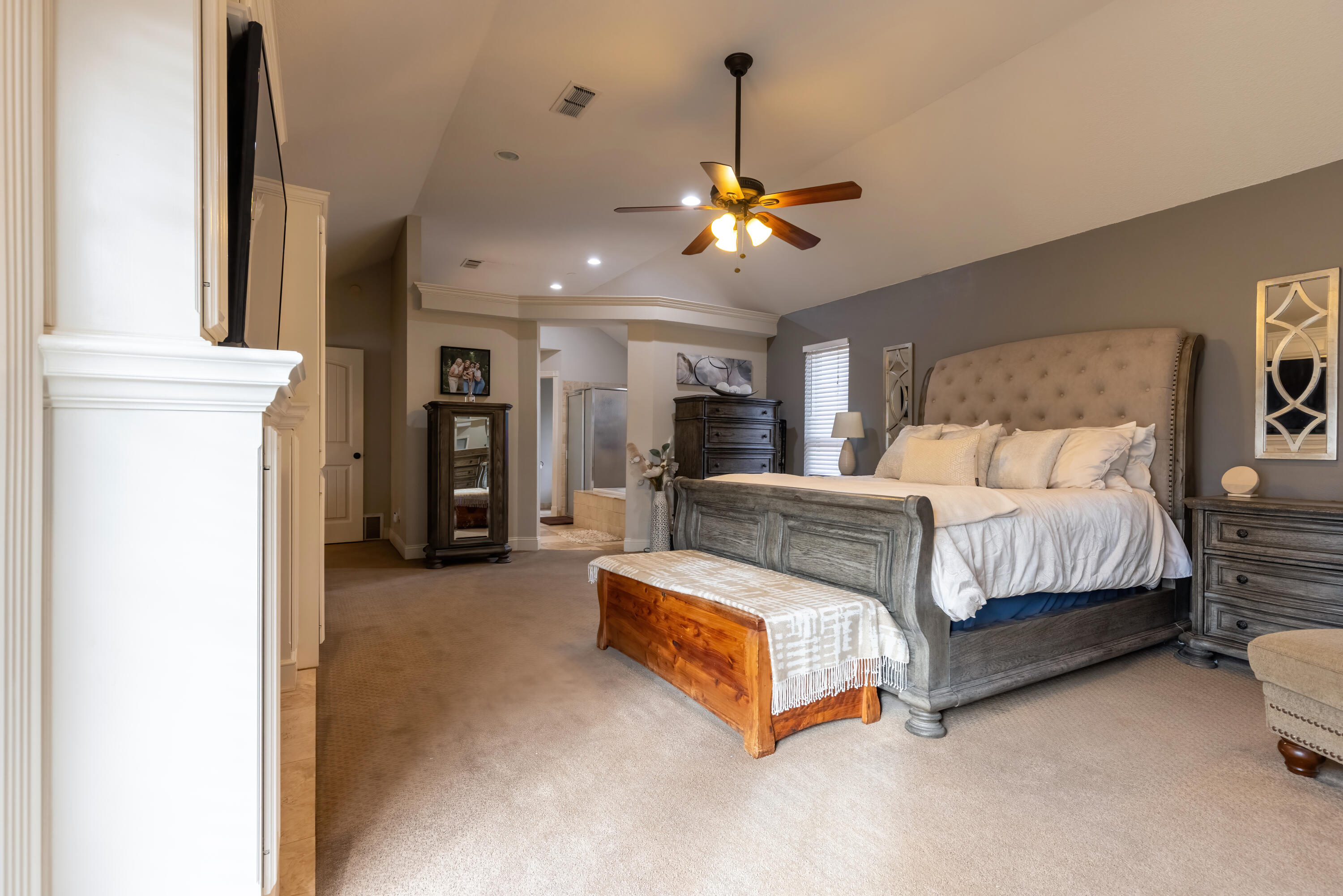 7807 Homestead Avenue Lubbock, TX 79424 - Photo 17 of 31 a spacious bedroom with a bed and a chandelier