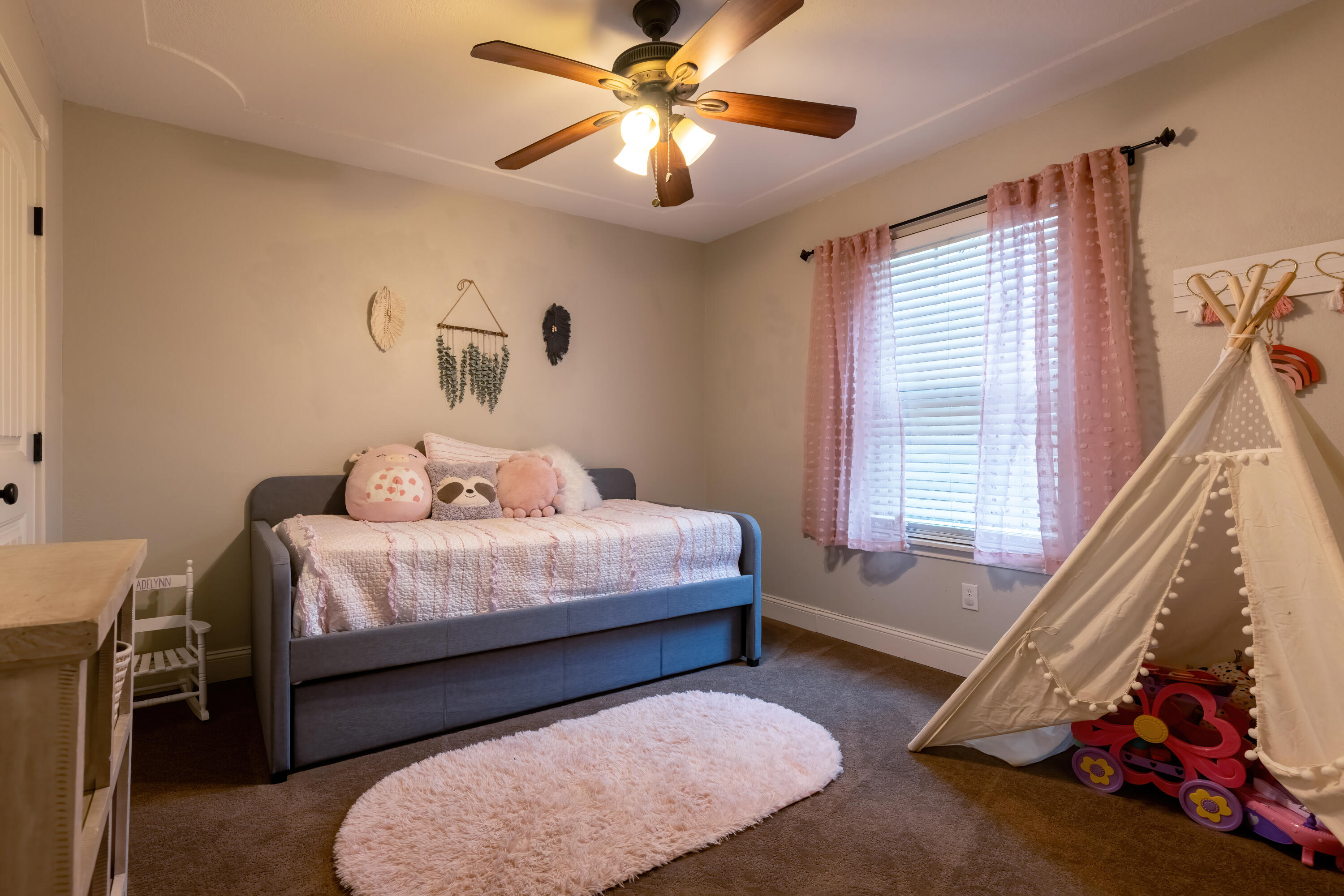 7807 Homestead Avenue Lubbock, TX 79424 - Photo 20 of 31 a bedroom with a bed and a chandelier