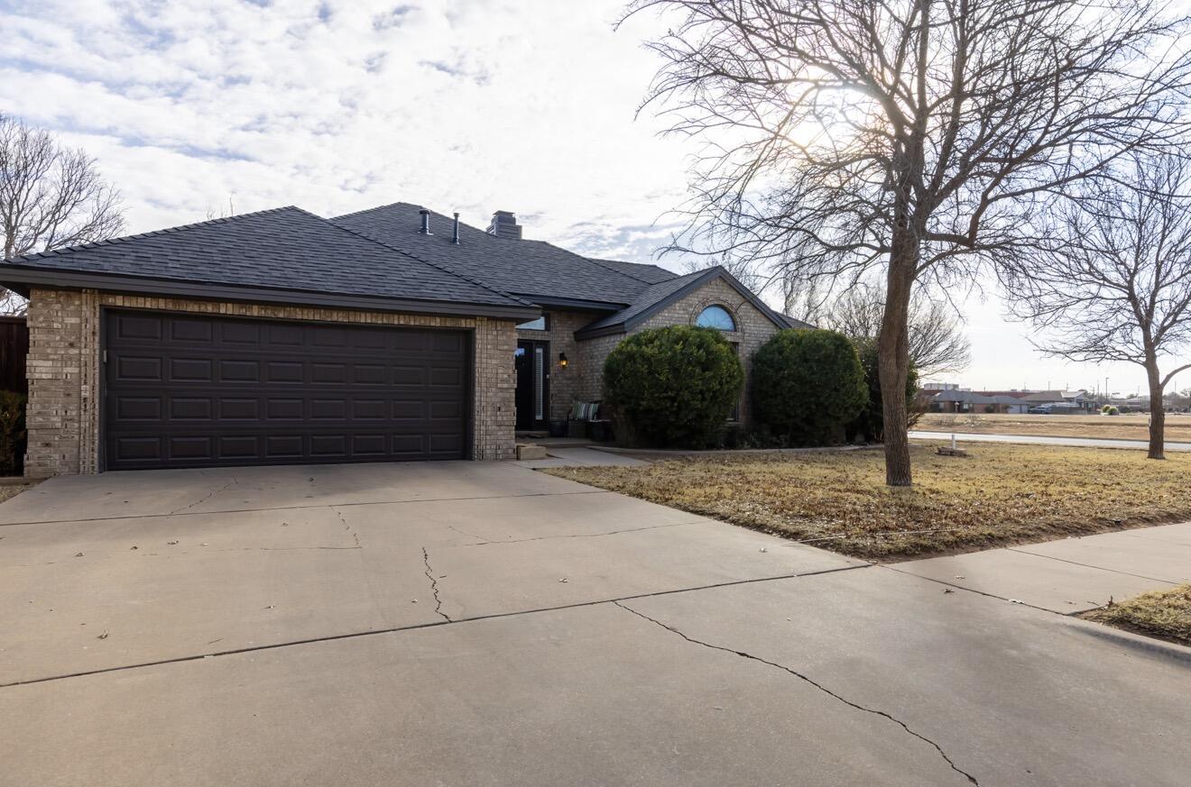 7807 Homestead Avenue Lubbock, TX 79424 - Photo 29 of 31 a front view of a house with a yard and garage