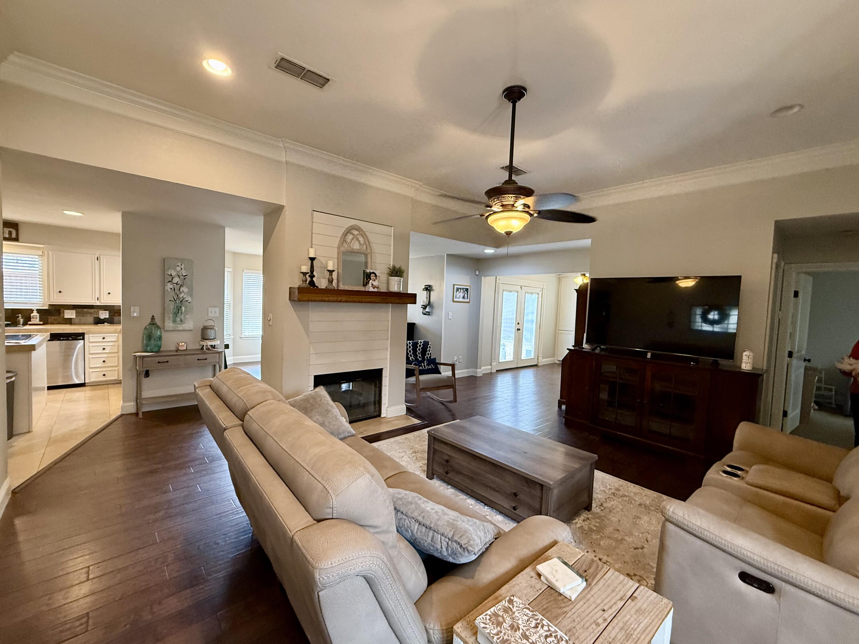 7807 Homestead Avenue Lubbock, TX 79424 - Photo 3 of 31 a living room with furniture fireplace and a flat screen tv