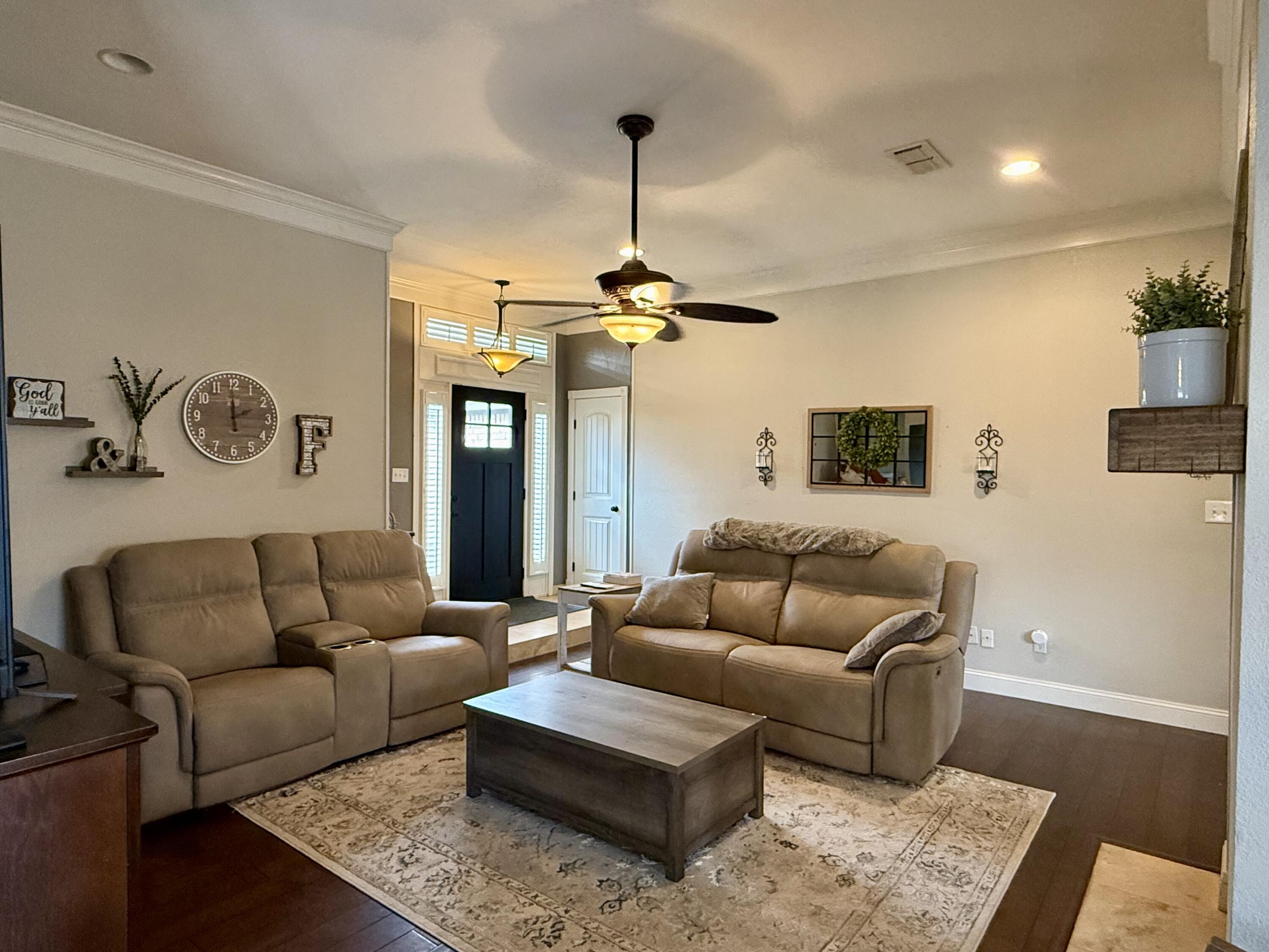 7807 Homestead Avenue Lubbock, TX 79424 - Photo 4 of 31 a living room with furniture and a chandelier