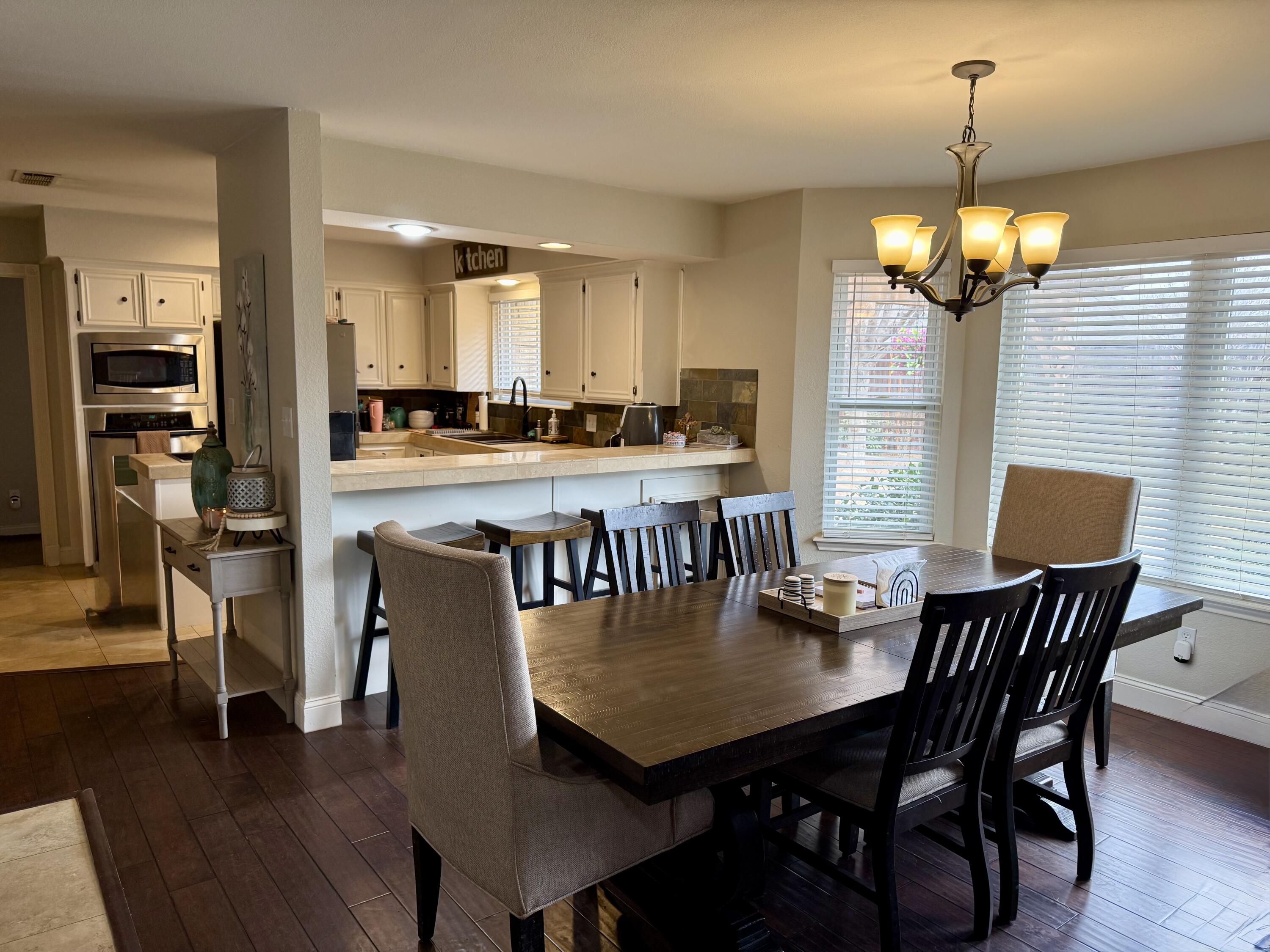 7807 Homestead Avenue Lubbock, TX 79424 - Photo 8 of 31 a view of a dining room with furniture and wooden floor
