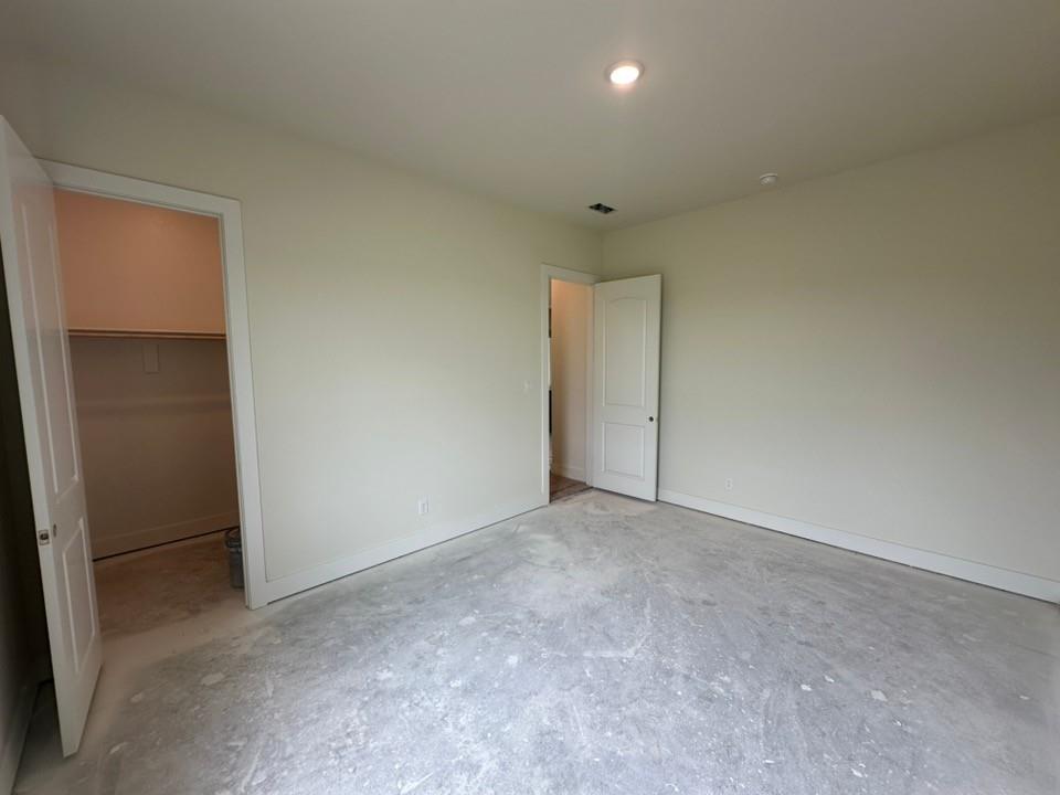 205 Cobb Road Leonard, TX 75452 - Photo 21 of 28 Spacious room featuring neutral painted walls, recessed ceiling lighting, and a walk-in closet with shelving
