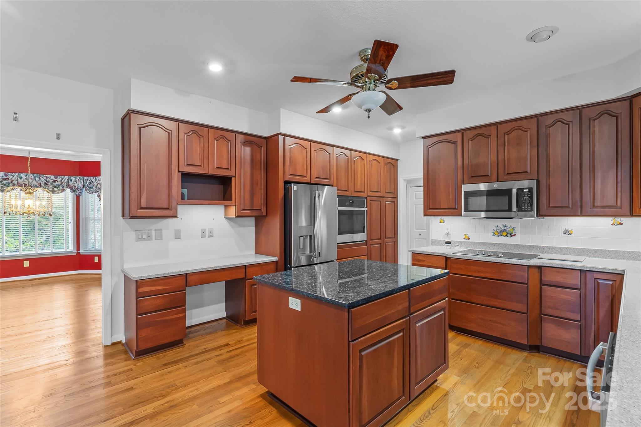 506 Kings Ridge Asheville, NC 28804 - Photo 12 of 44 a kitchen with stainless steel appliances granite countertop a sink stove and wooden cabinets