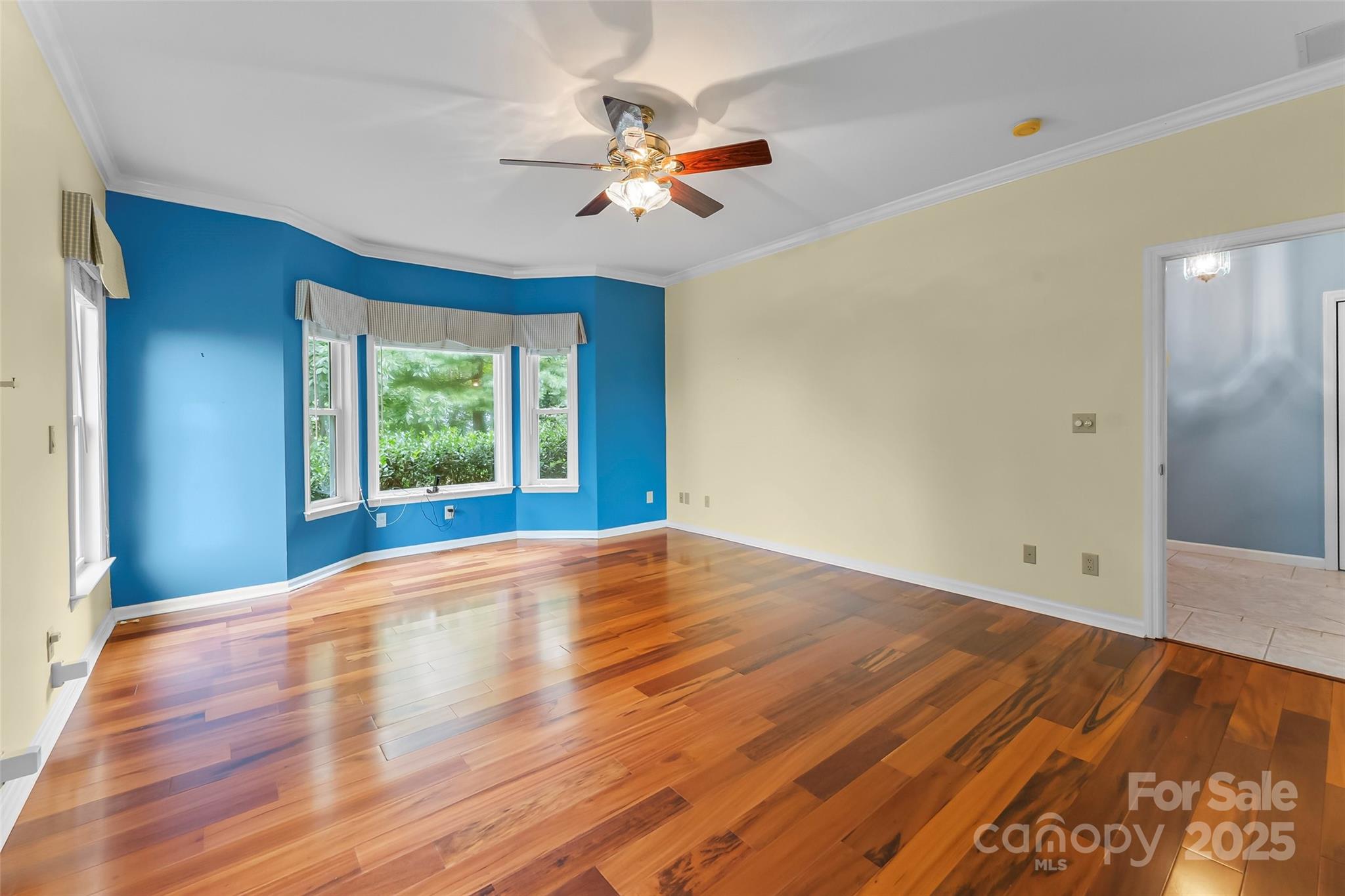 506 Kings Ridge Asheville, NC 28804 - Photo 16 of 44 a view of an empty room with wooden floor and a window
