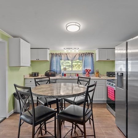 289 Brookside Road Athol, MA 01331 - Photo 6 of 22 a kitchen with a dining table chairs and refrigerator
