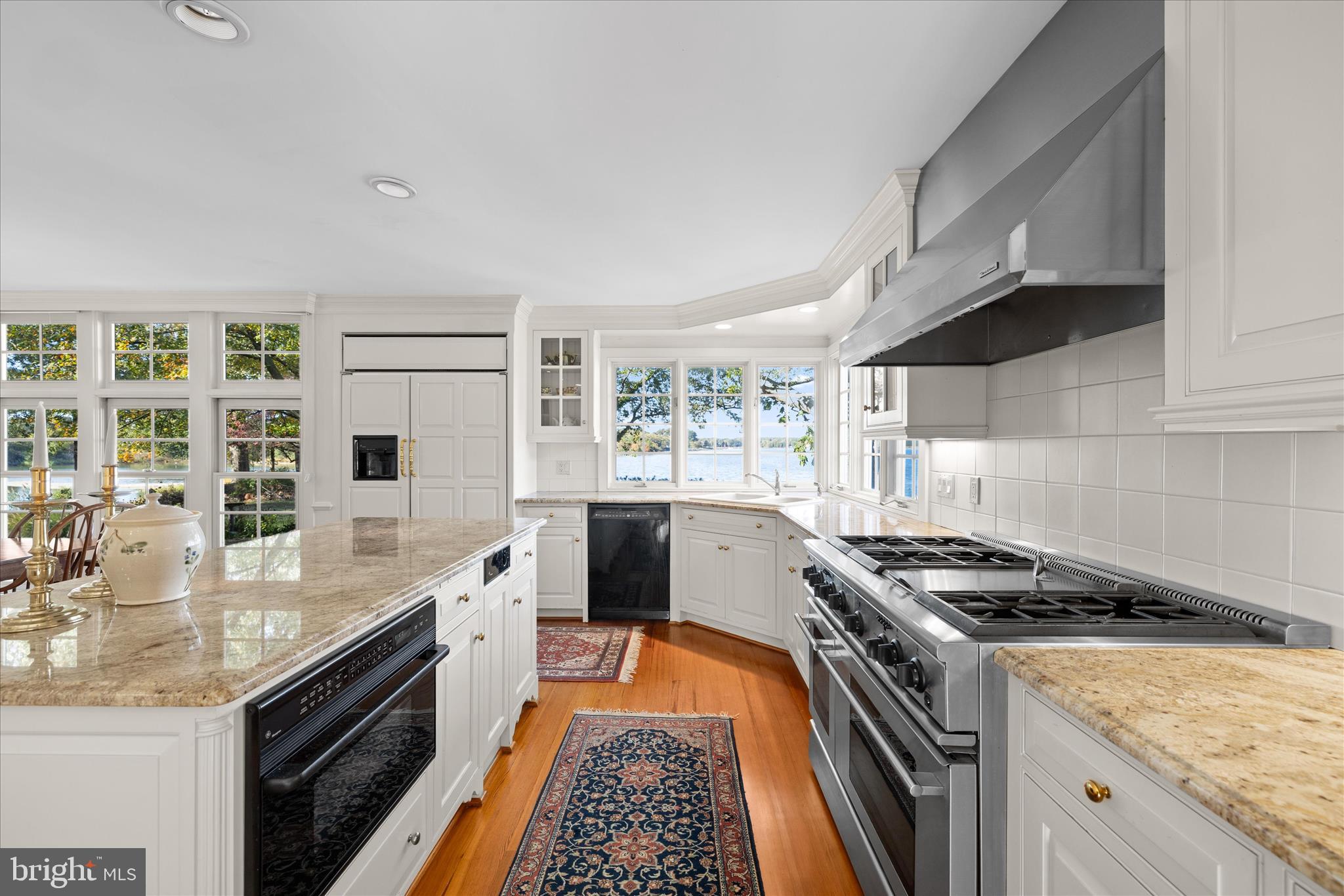 27473 Westpoint Road Easton, MD 21601 - Photo 18 of 58 a kitchen with stainless steel appliances granite countertop a stove a sink and a microwave