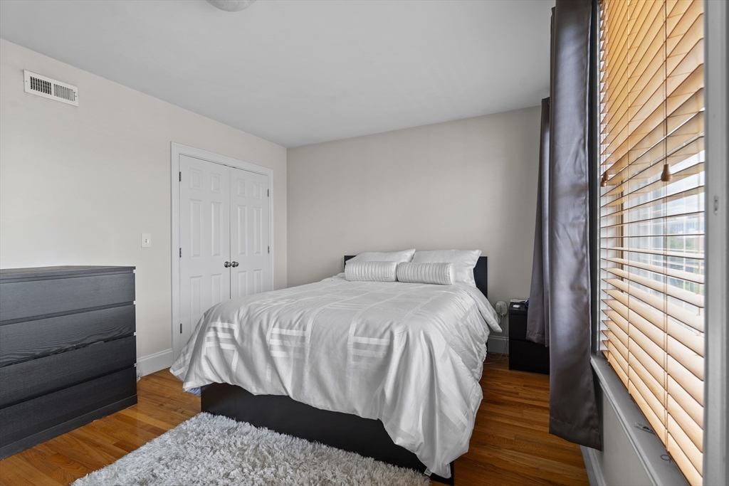 320 West Broadway, Unit 6 Boston, MA 02127 - Photo 7 of 14 a bedroom with a bed and a mirror