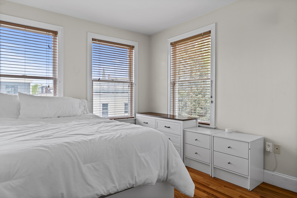 320 West Broadway, Unit 6 Boston, MA 02127 - Photo 10 of 14 a spacious bedroom with a bed and a window
