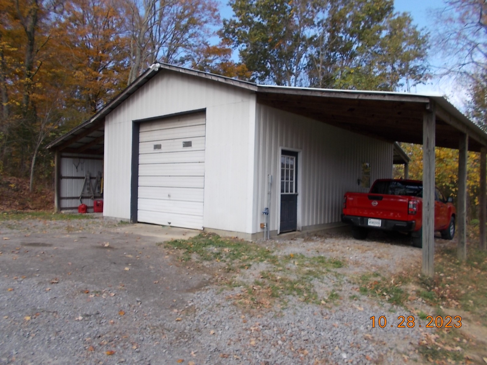 260 Round Top Road Alexandria, TN 37012 - Photo 28 of 65 a view of garage and a car parked in it