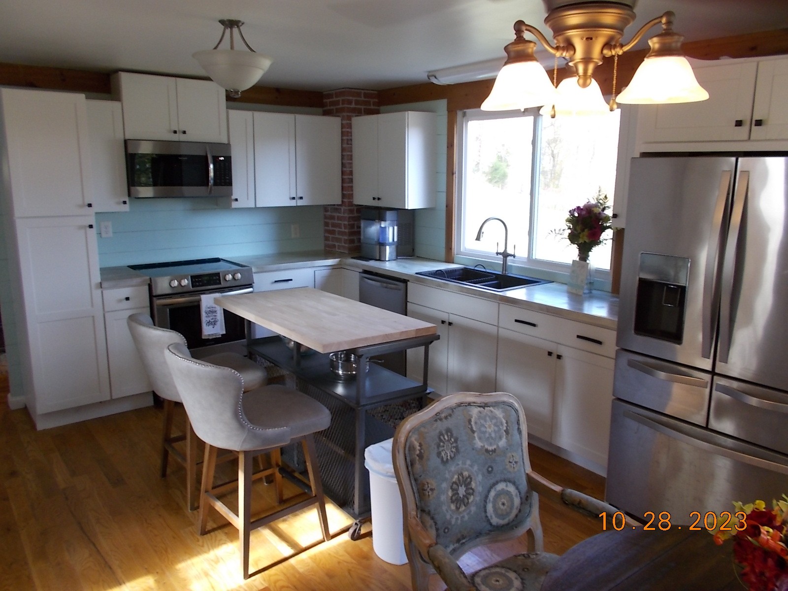260 Round Top Road Alexandria, TN 37012 - Photo 33 of 65 a kitchen with stainless steel appliances granite countertop a stove a refrigerator a sink a dining table and chairs with wooden floor