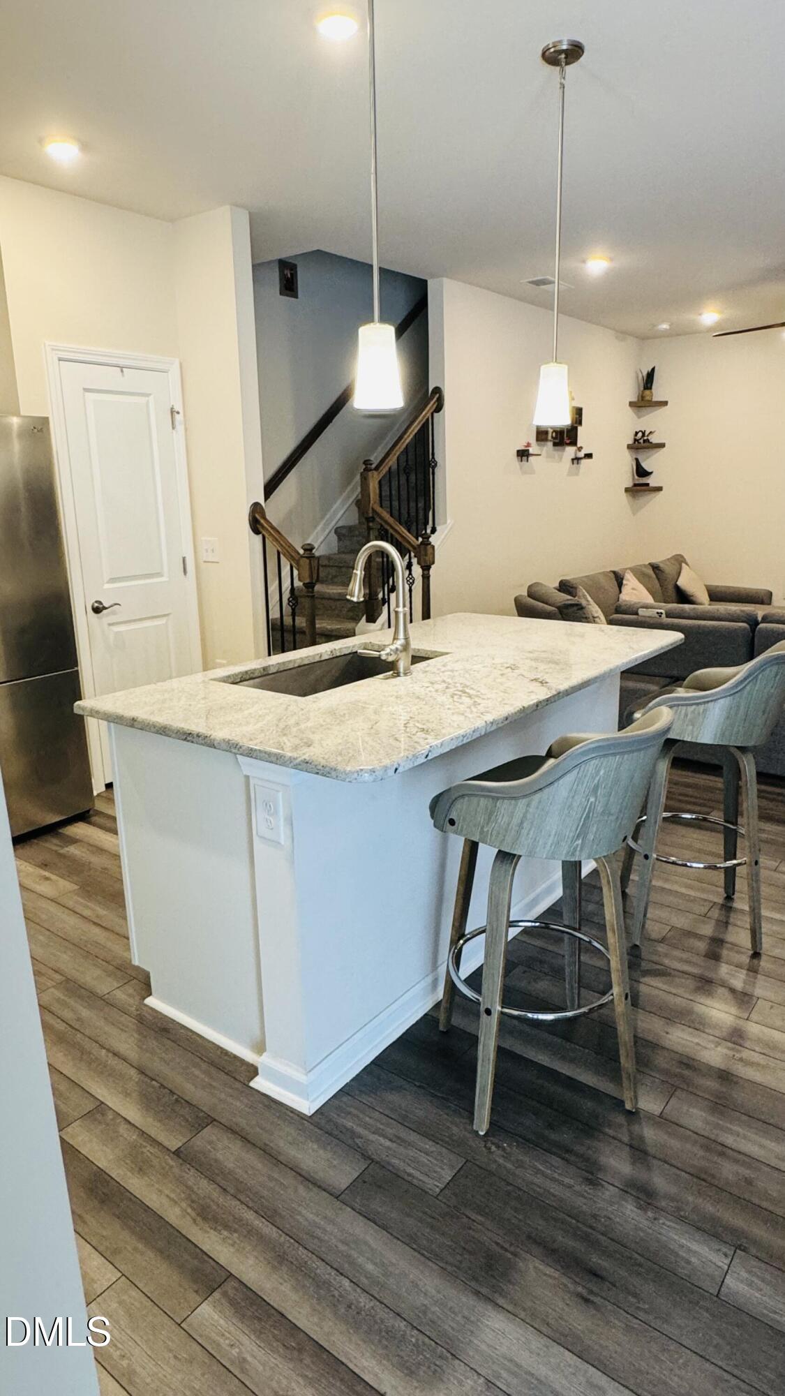 4218 Congleton Place Durham, NC 27703 - Photo 5 of 19 a view of a kitchen area with furniture and wooden floor