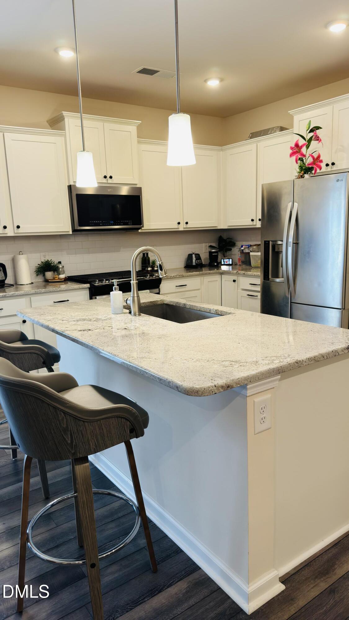 4218 Congleton Place Durham, NC 27703 - Photo 6 of 19 a kitchen with stainless steel appliances granite countertop a sink a stove and a wooden floors