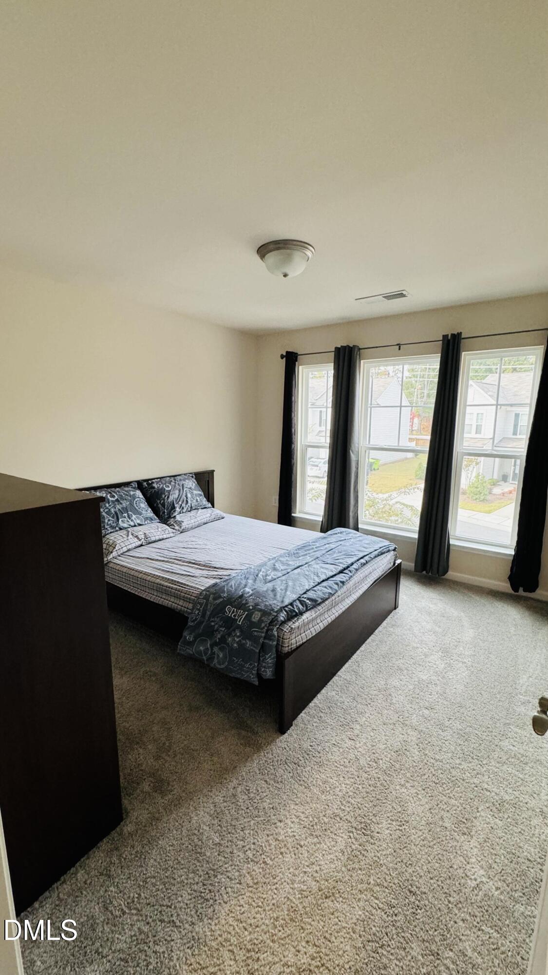 4218 Congleton Place Durham, NC 27703 - Photo 10 of 19 a bedroom with a bed and a large window