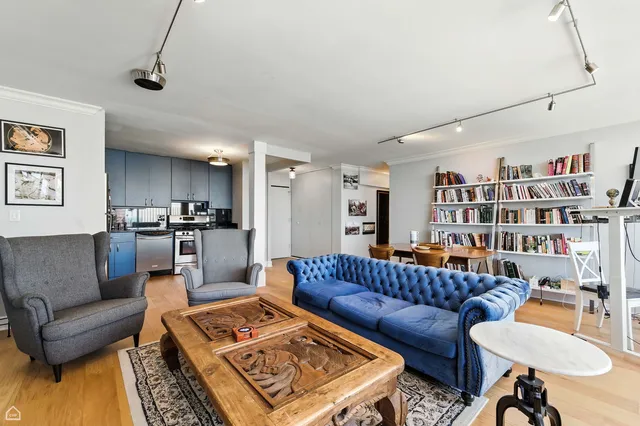 a living room with furniture and a book shelf
