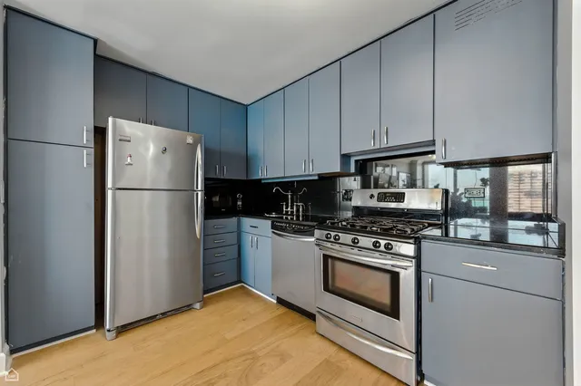a kitchen with cabinets and stainless steel appliances