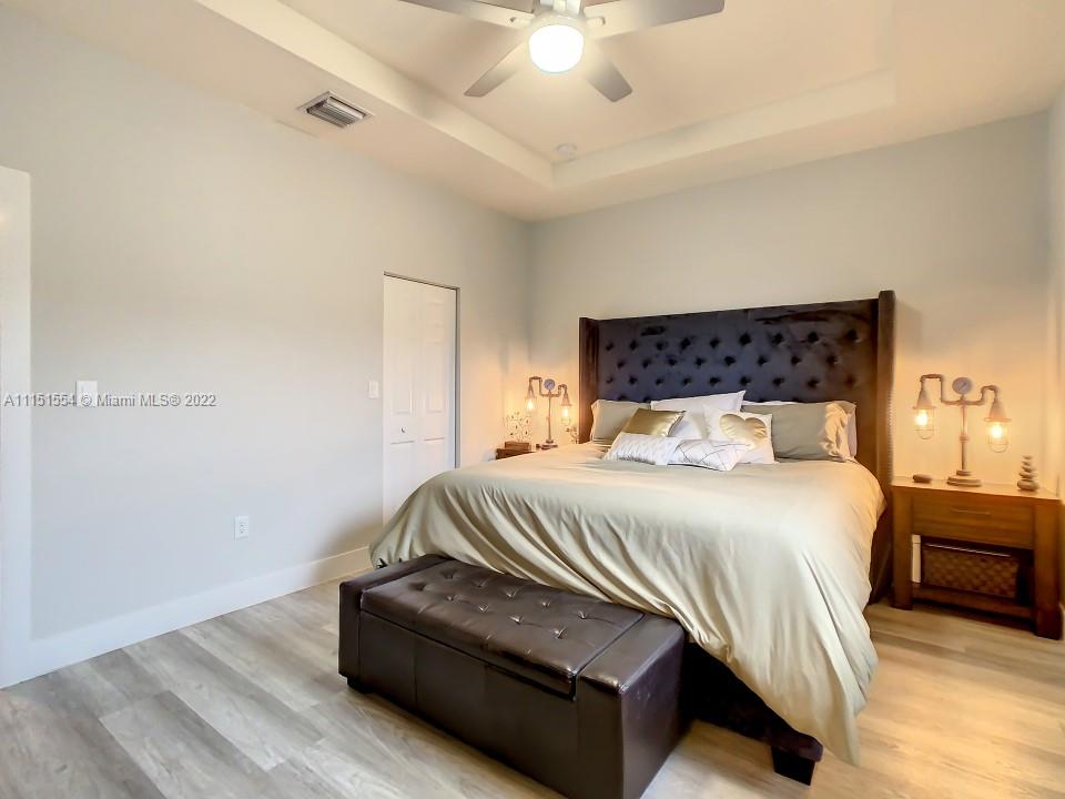 9326 West 33rd Lane Hialeah, FL 33018 - Photo 12 of 52 a bedroom with a bed and a ceiling fan