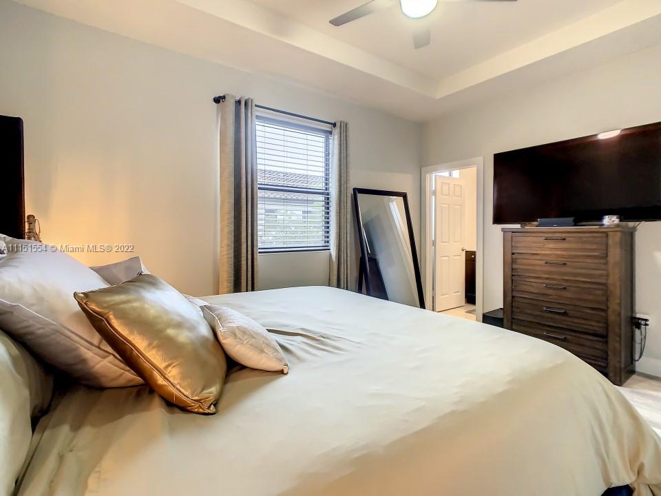 9326 West 33rd Lane Hialeah, FL 33018 - Photo 15 of 52 a bedroom with a bed and a flat screen tv