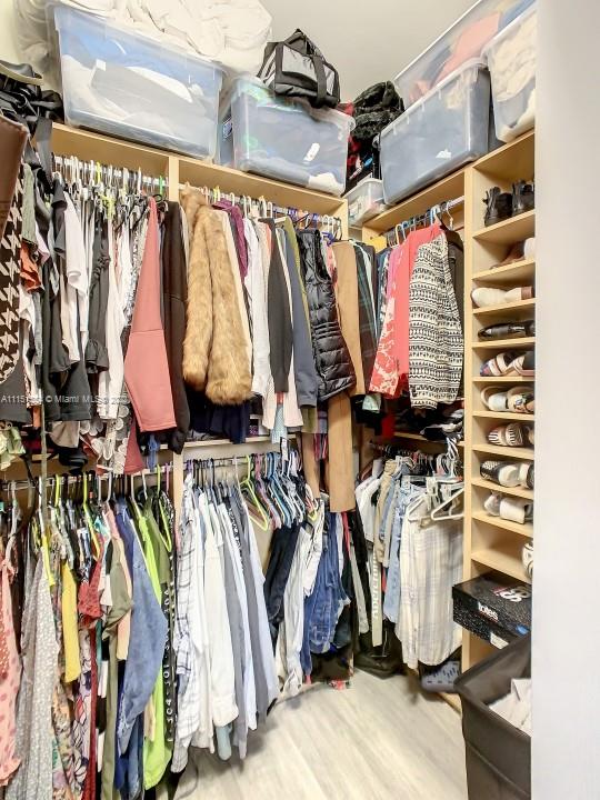 9326 West 33rd Lane Hialeah, FL 33018 - Photo 16 of 52 a view of walk in closet with clothes and shoes
