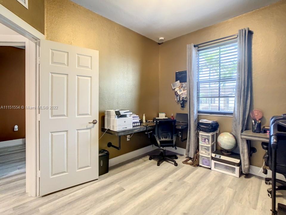 9326 West 33rd Lane Hialeah, FL 33018 - Photo 18 of 52 a view of a workspace with furniture and a window