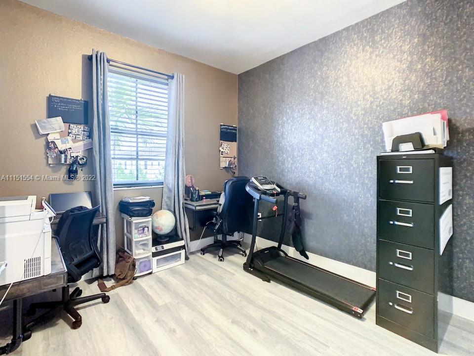9326 West 33rd Lane Hialeah, FL 33018 - Photo 19 of 52 a view of a workspace with furniture and a window