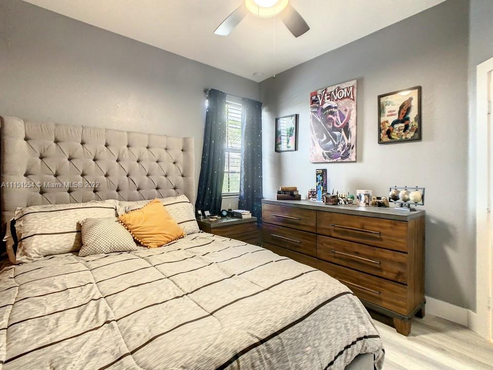 9326 West 33rd Lane Hialeah, FL 33018 - Photo 23 of 52 a bedroom with a bed and cabinets