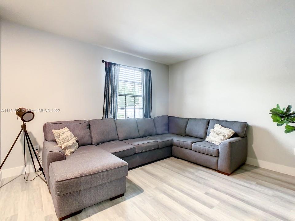 9326 West 33rd Lane Hialeah, FL 33018 - Photo 3 of 52 a living room with a couch and a window