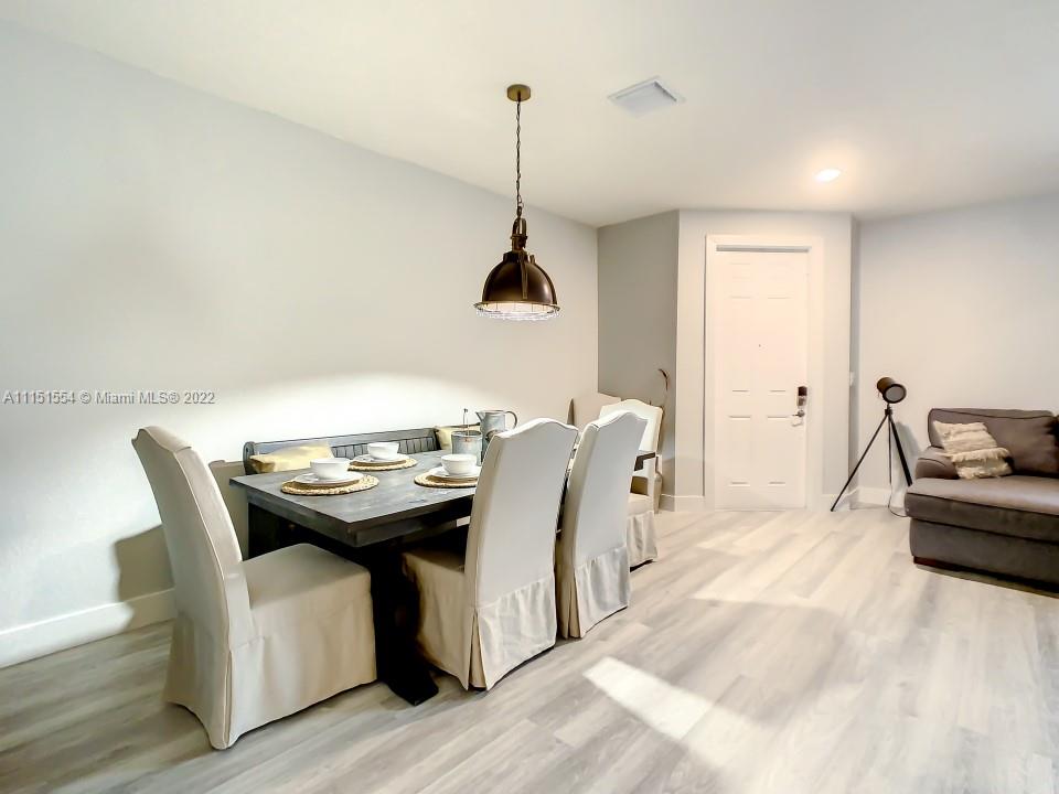 9326 West 33rd Lane Hialeah, FL 33018 - Photo 39 of 52 a living room with furniture and a wooden floor