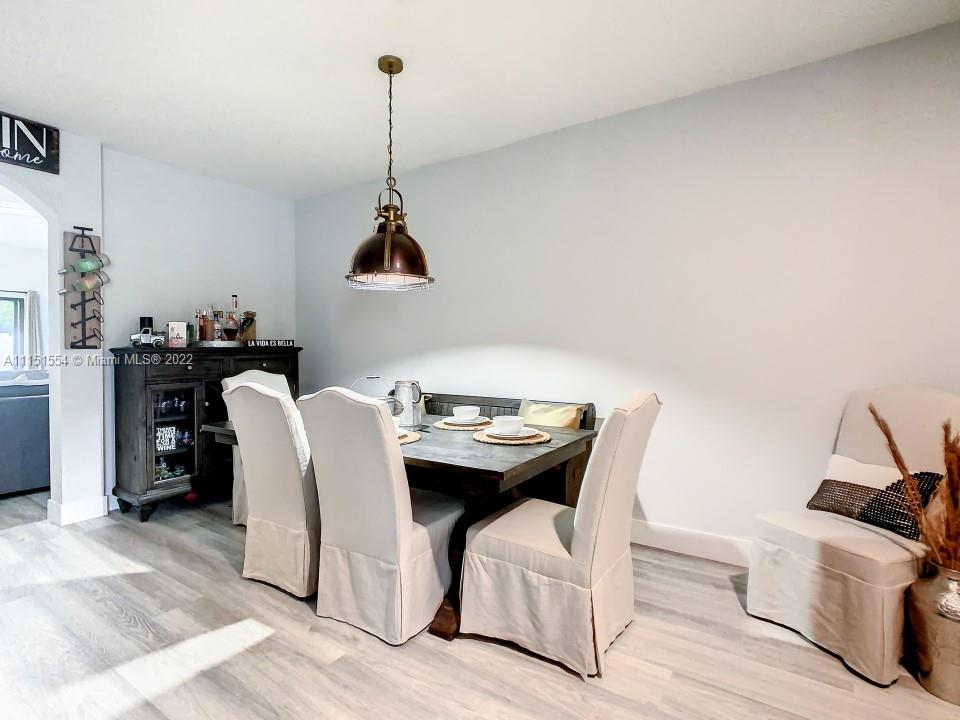 9326 West 33rd Lane Hialeah, FL 33018 - Photo 40 of 52 a view of a dining room with furniture and wooden floor