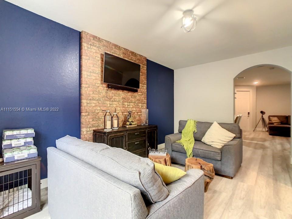 9326 West 33rd Lane Hialeah, FL 33018 - Photo 6 of 52 a living room with furniture and a flat screen tv