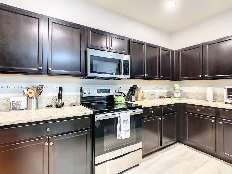 9326 West 33rd Lane Hialeah, FL 33018 - Photo 8 of 52 a kitchen with a sink stove top oven and cabinets